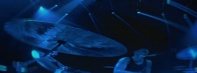 a man playing drums on stage at a concert