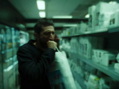 a man in a store holding a newspaper