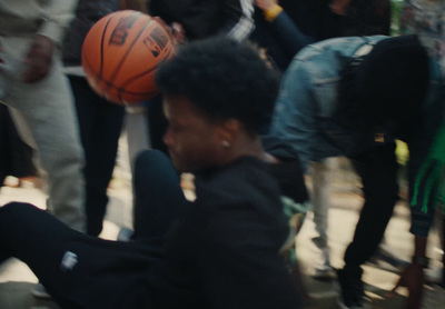 a man sitting on the ground with a basketball in his hand