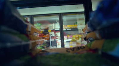 a store window with a fake teddy bear in front of it