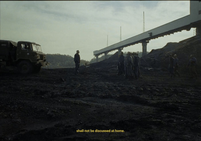 a group of people standing in a dirt field