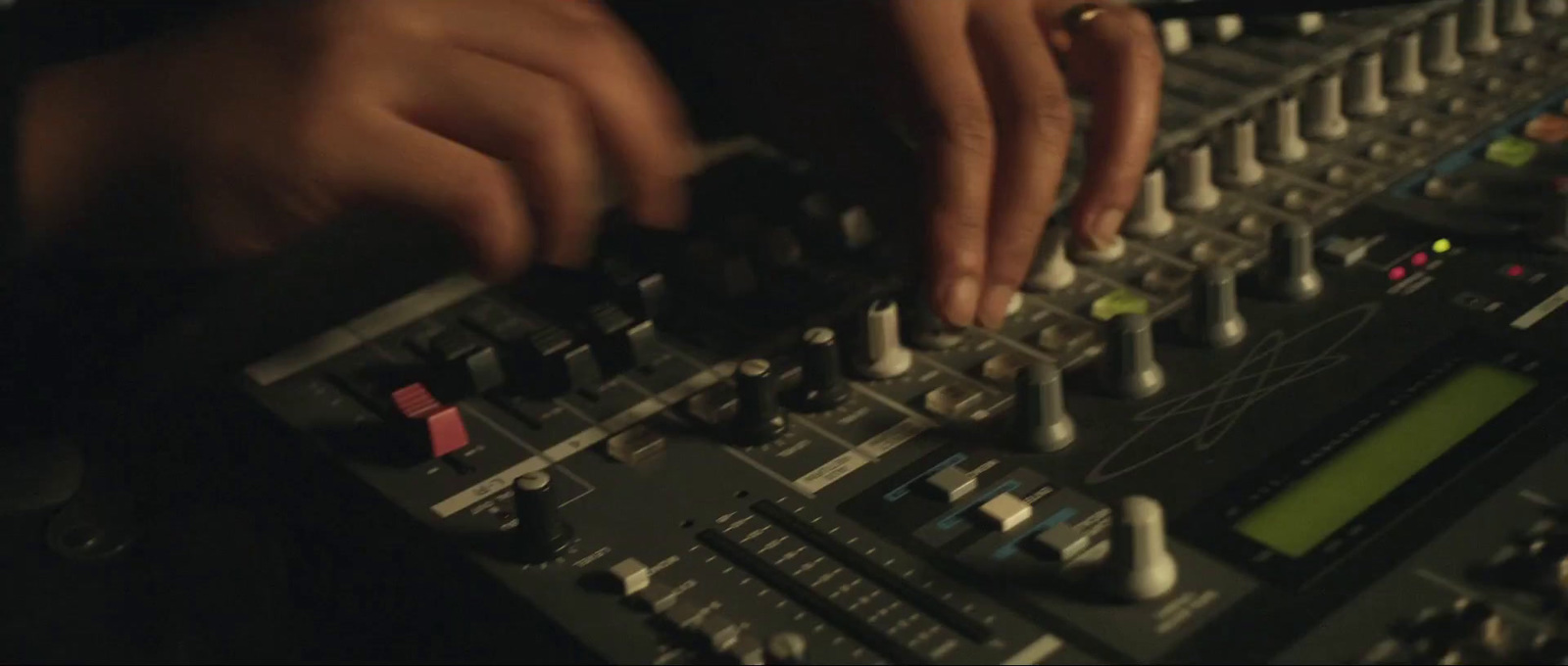 a close up of a person touching a sound board