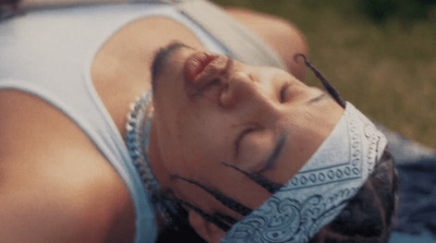 a woman laying on the ground with her eyes closed