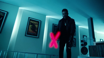 a man standing in a room with a red x on his chest