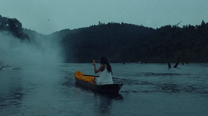 a woman sitting in a canoe on a lake