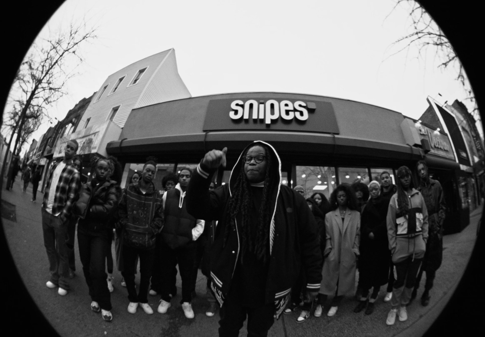 a group of people standing in front of a store