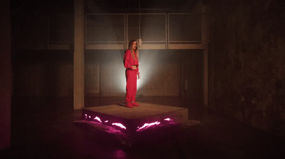 a woman standing on top of a box in a dark room