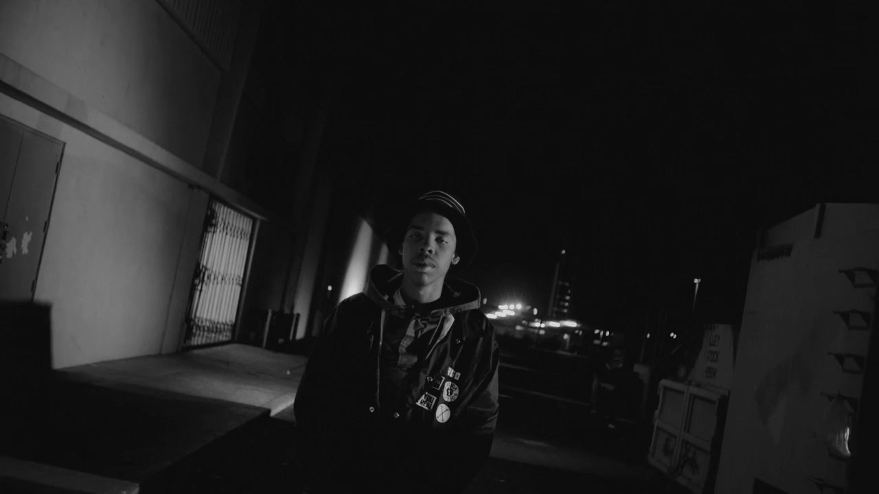 a man standing in a dark alley at night