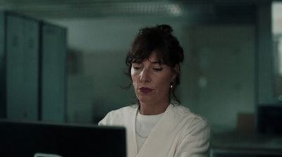 a woman sitting in front of a laptop computer