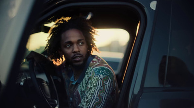 a man with dreadlocks sitting in a car