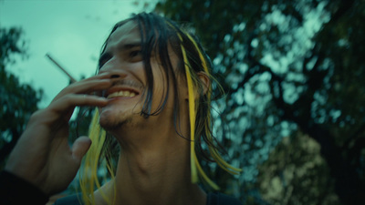 a man with dreadlocks smoking a cigarette