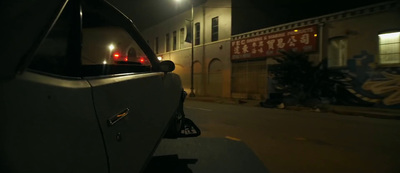 a car parked on the side of a street at night