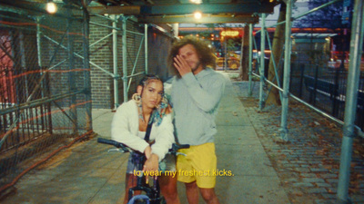 a man standing next to a woman on a bike