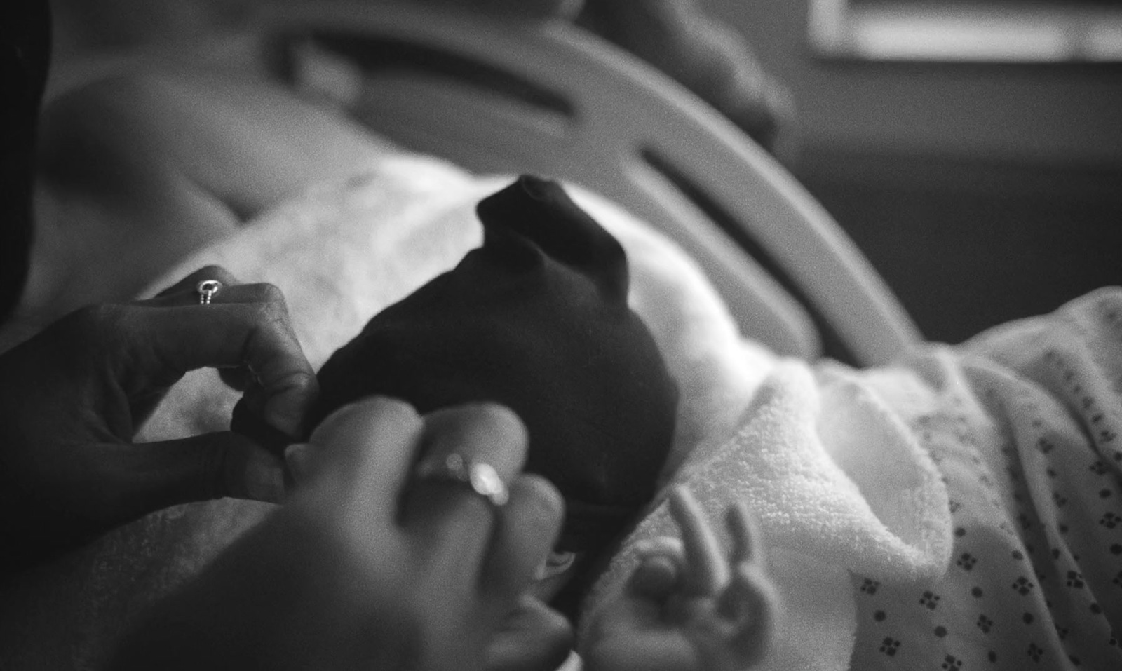 a black and white photo of a baby in a crib