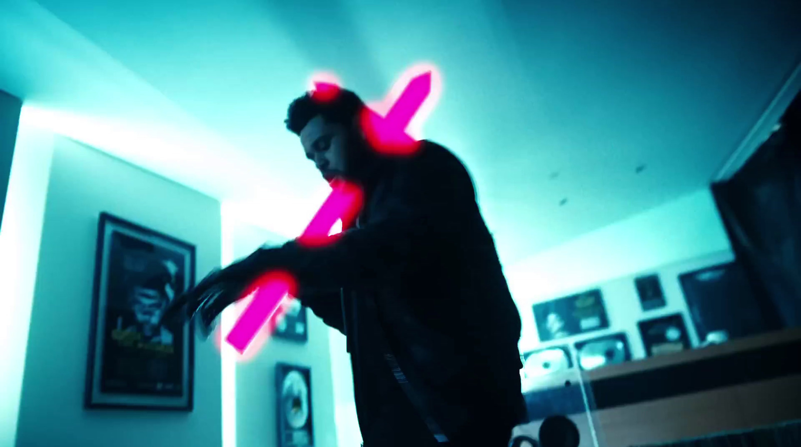 a man standing in a room holding a neon pink object