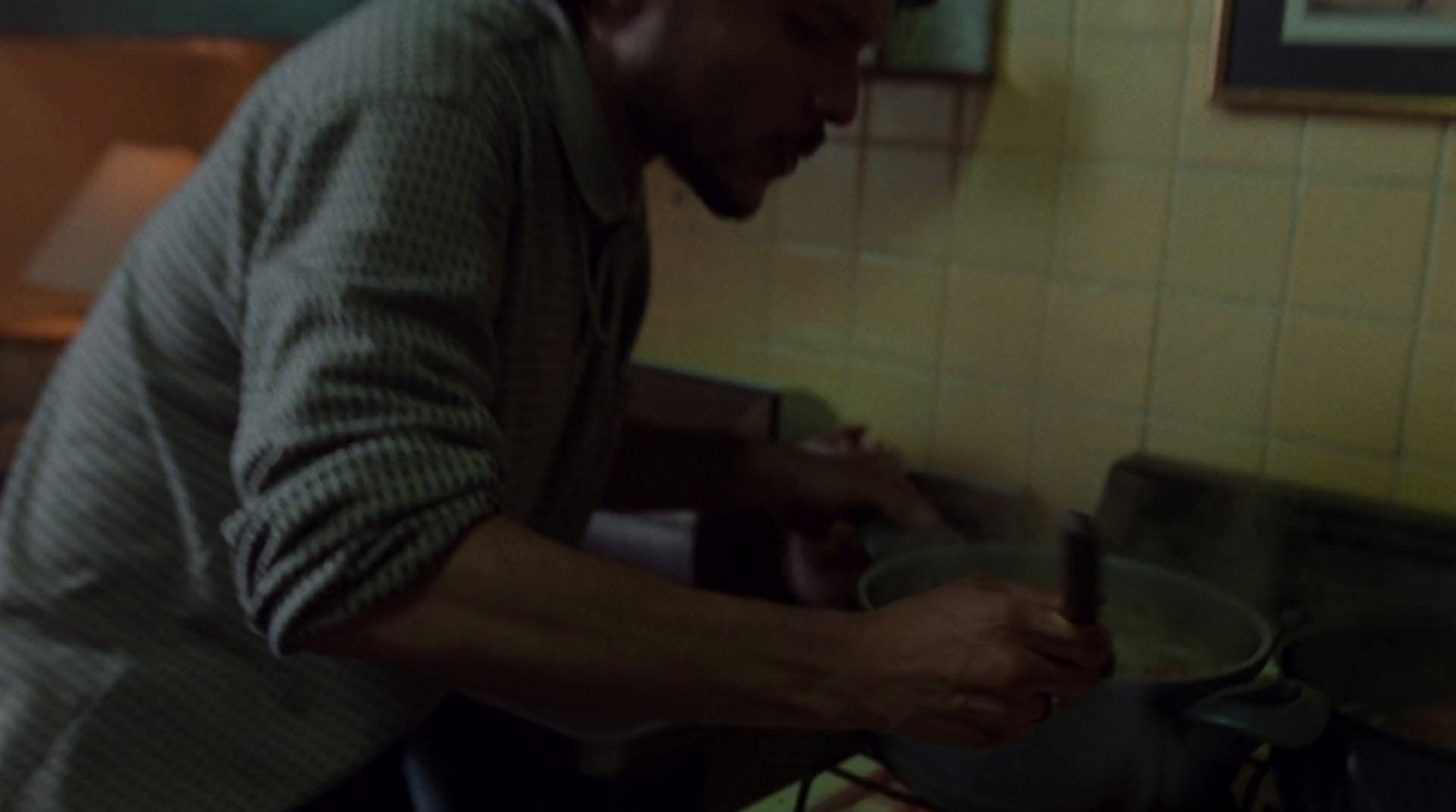 a man standing in a kitchen preparing food