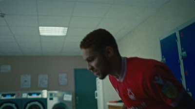 a man in a red shirt looking at a cell phone