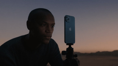 a man holding a cell phone up to a camera