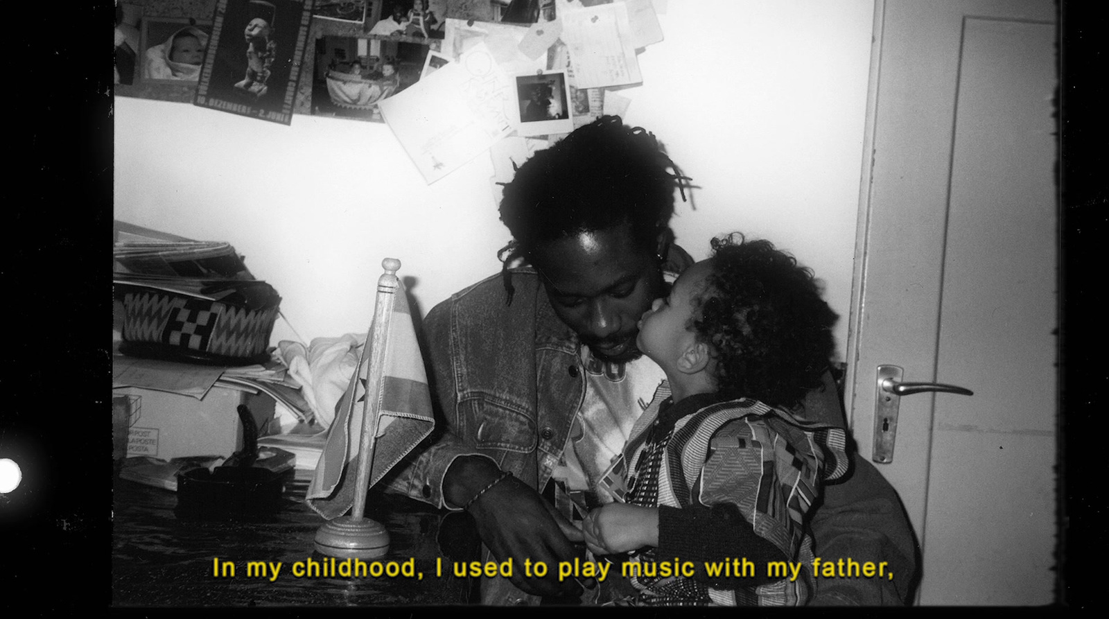 a black and white photo of a man kissing a little girl