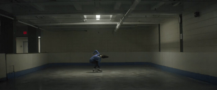 a person on a skateboard in a dark room