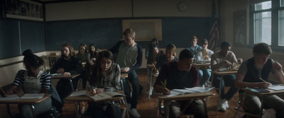 a group of students sitting at desks in a classroom