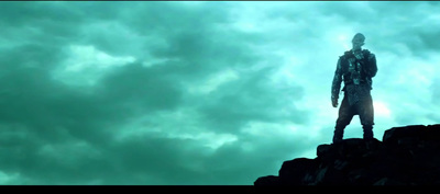 a man standing on top of a rocky cliff