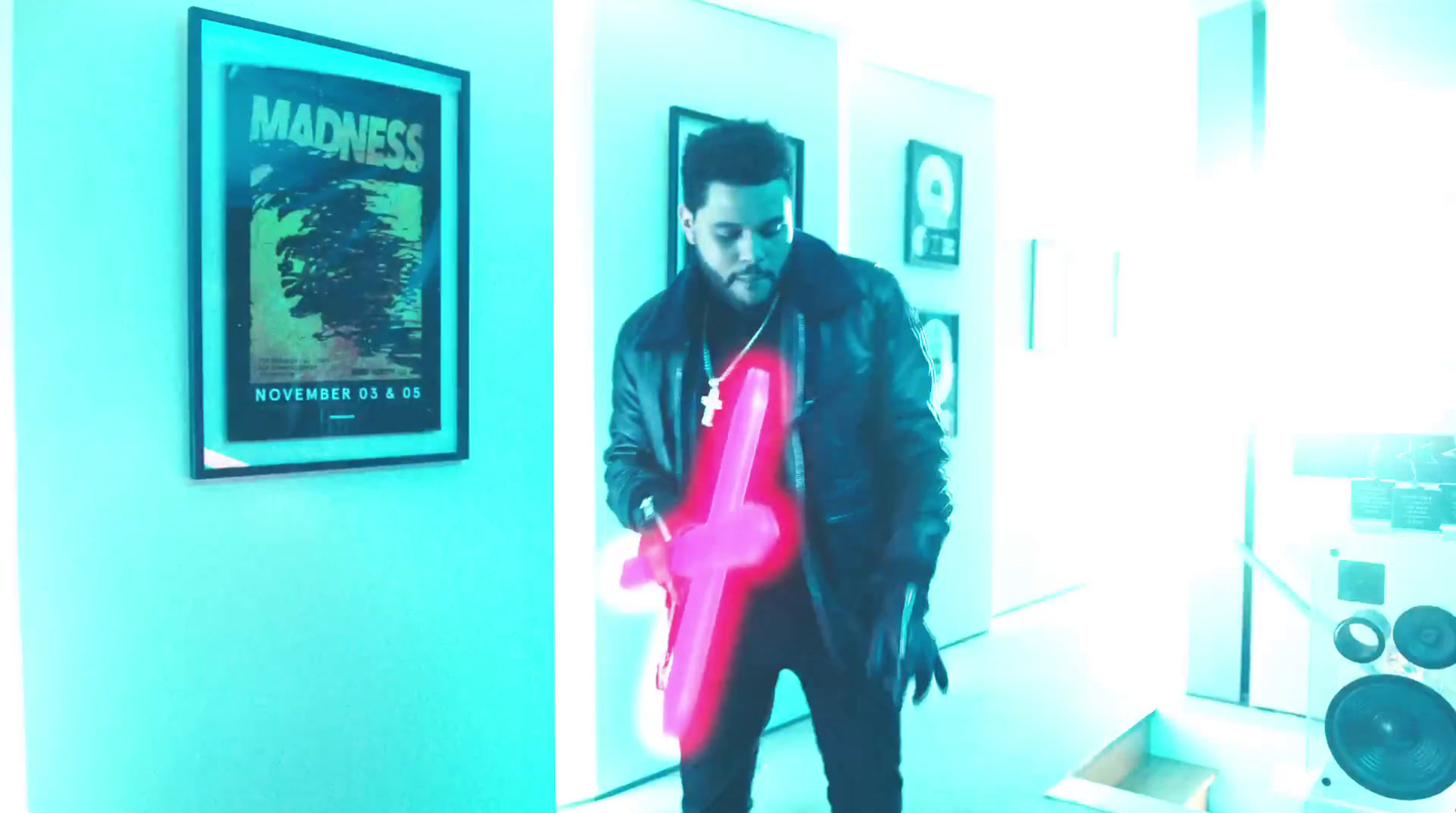 a man holding a neon pink object in a room