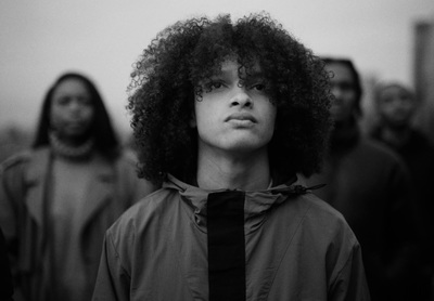 a black and white photo of a man with curly hair