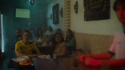 a group of people sitting at a table in a restaurant