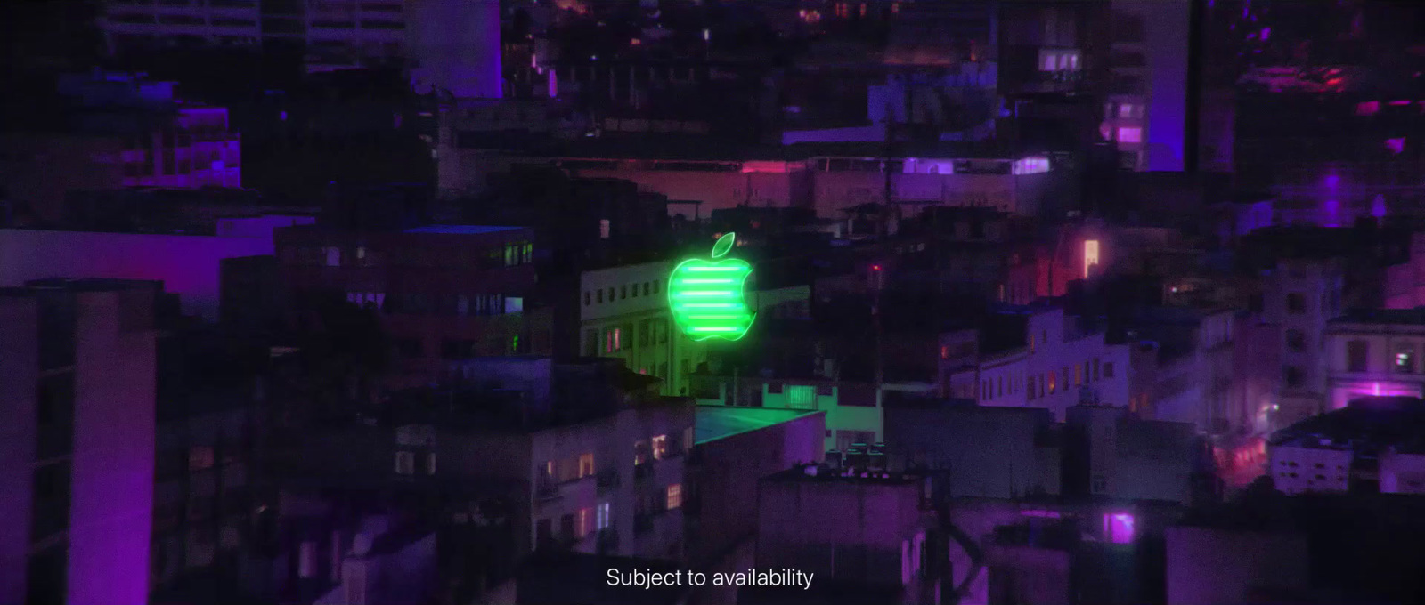 a green light on top of a building in a city