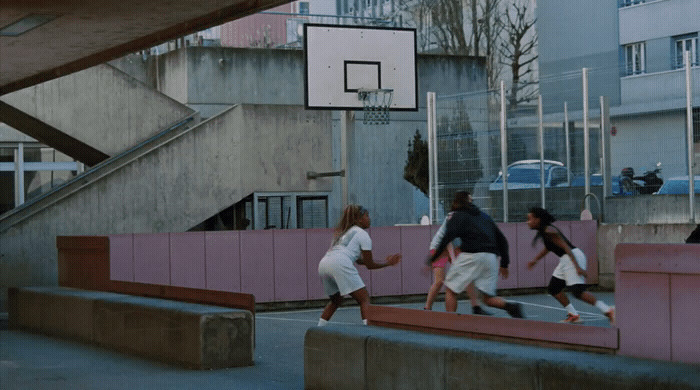 a group of people playing basketball on a court