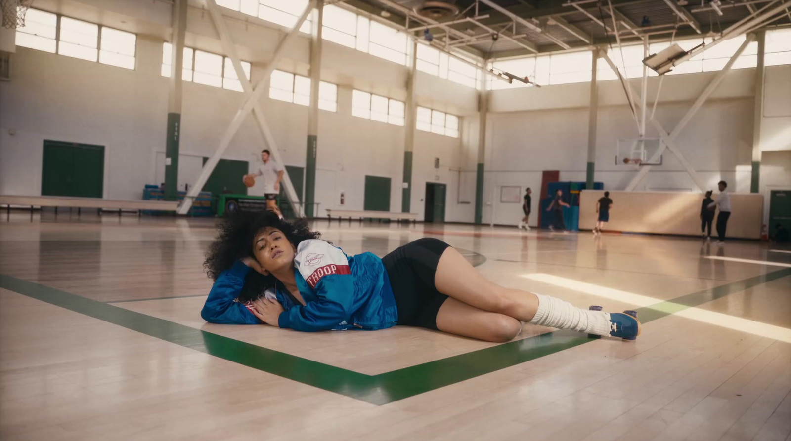 a woman laying on the floor in a gym