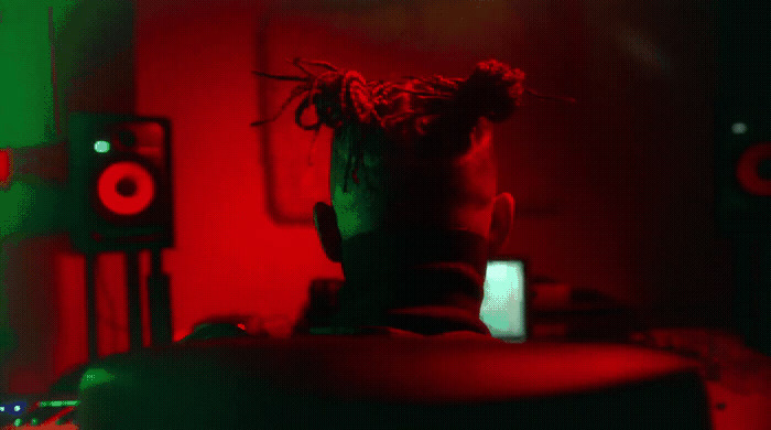 a man with dreadlocks sitting in a room