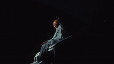 a man sitting on a ledge in the dark