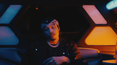 a man sitting in a car with a headband on