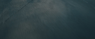 a man riding a snowboard down a snow covered slope