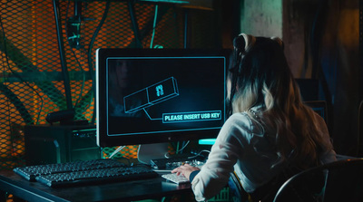 a woman sitting at a desk in front of a computer