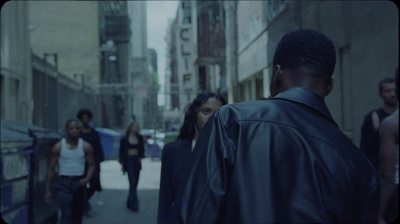 a group of people walking down a city street