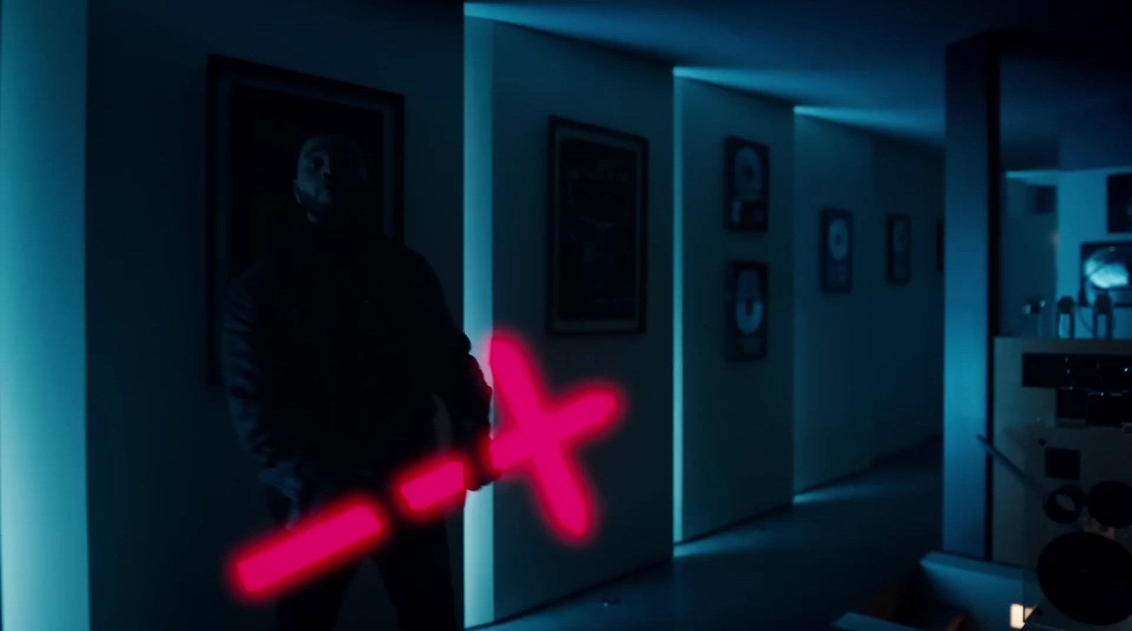 a man standing in a hallway with a red light