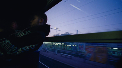 a man looking out a window at a train