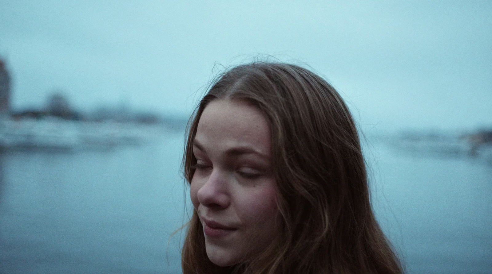 a close up of a person near a body of water