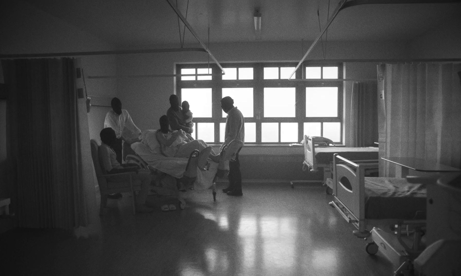 a black and white photo of a hospital room