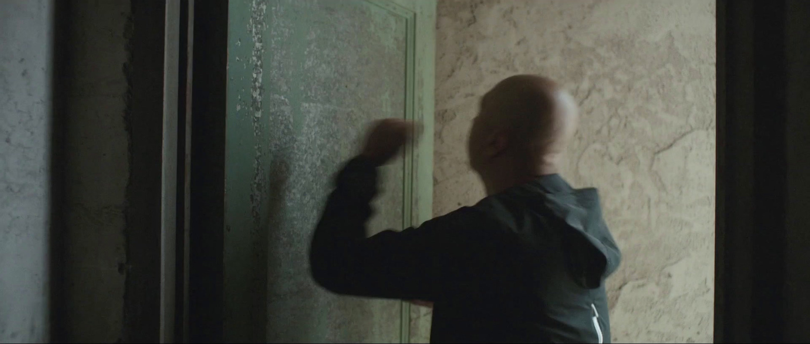 a man standing in front of a door in a room