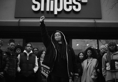 a group of people standing outside of a store