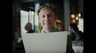 a man holding a piece of paper in front of his face