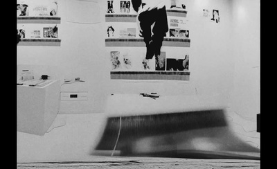 a black and white photo of a skateboarder doing a trick