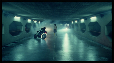 a man standing next to a motorcycle in a tunnel