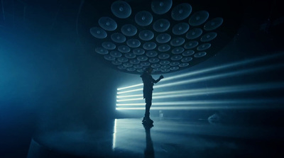 a person standing in front of a stage with lights