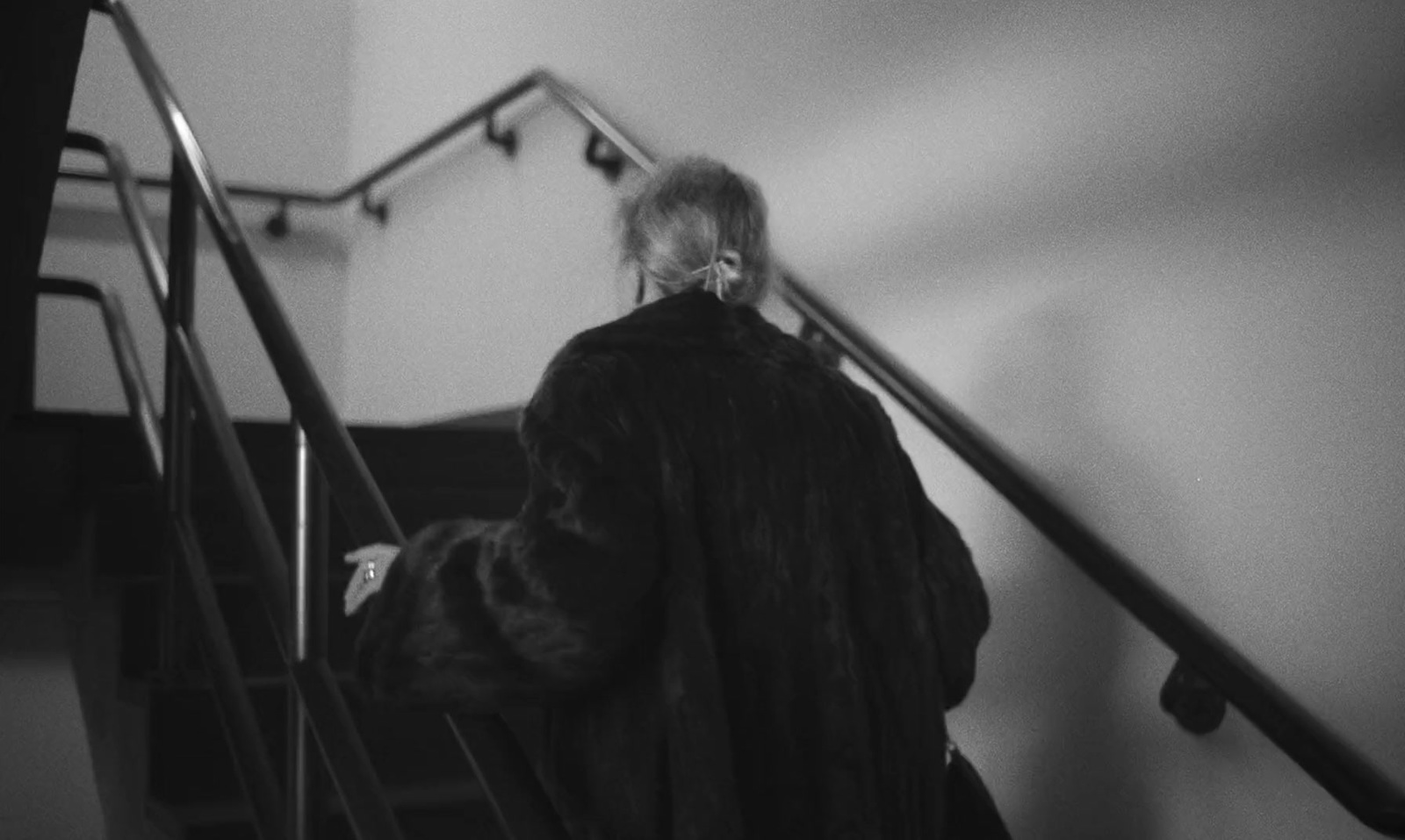 a woman walking down a flight of stairs