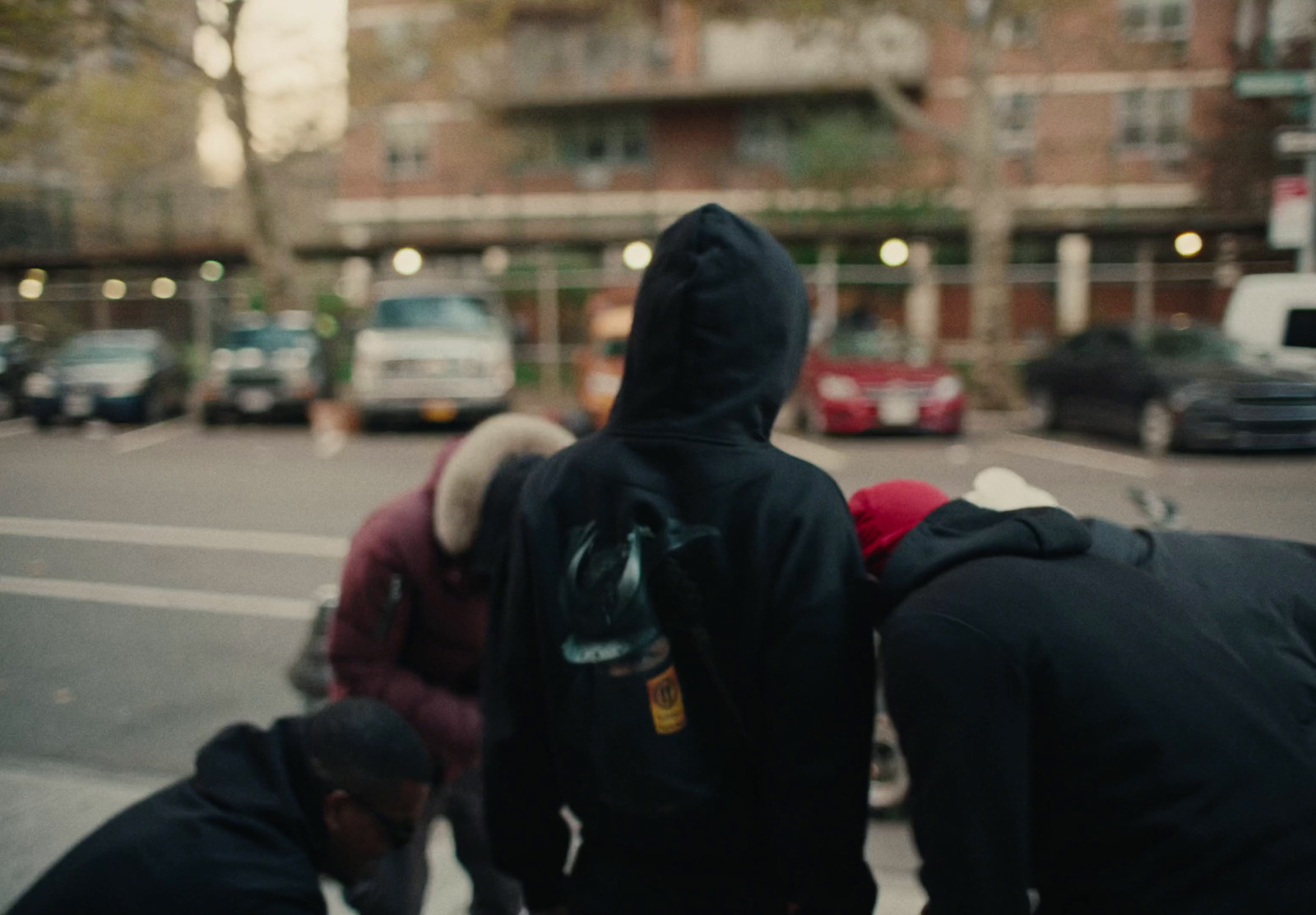 a group of people standing on the side of a road